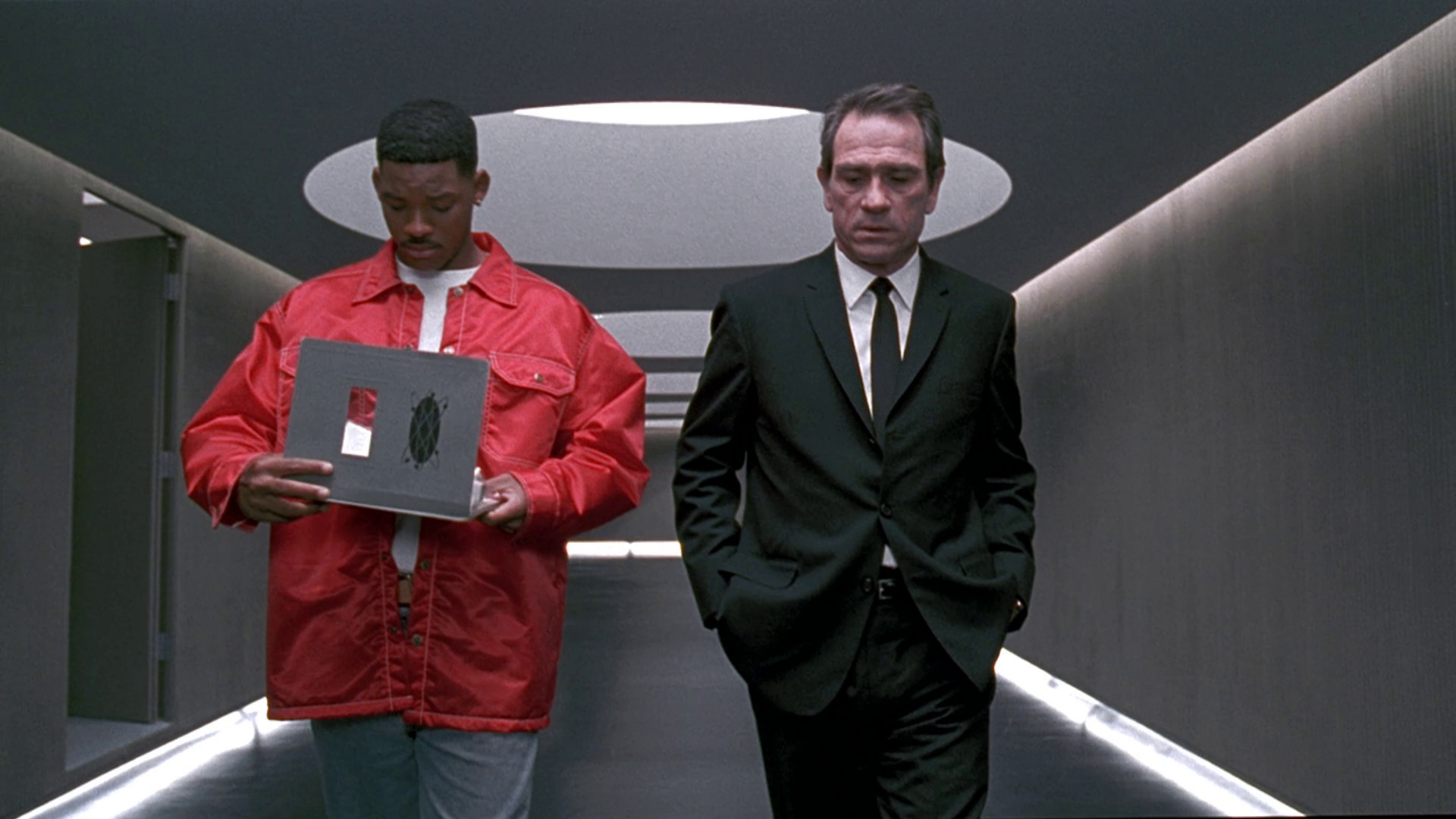 Still from Men in Black: Will Smith and Tommy Lee Jones walking a corridor