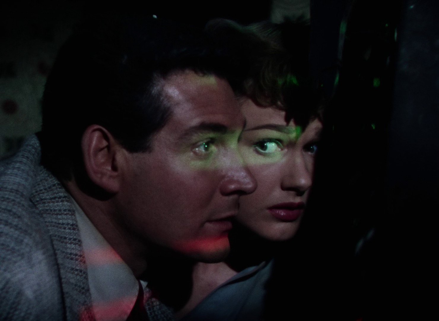 Still from The War of the Worlds (1953): Gene Barry and Ann Robinson lit by scanning light